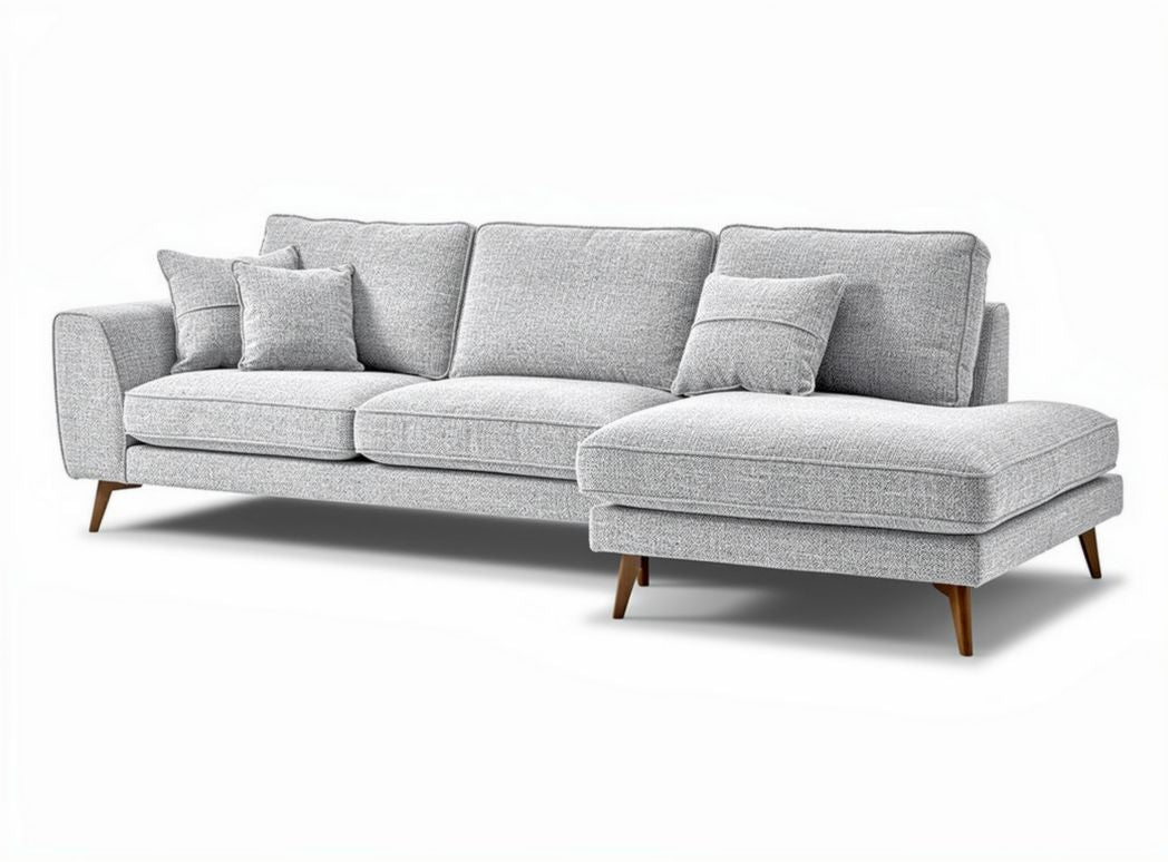Gray fabric sectional sofa with wooden legs and two decorative pillows